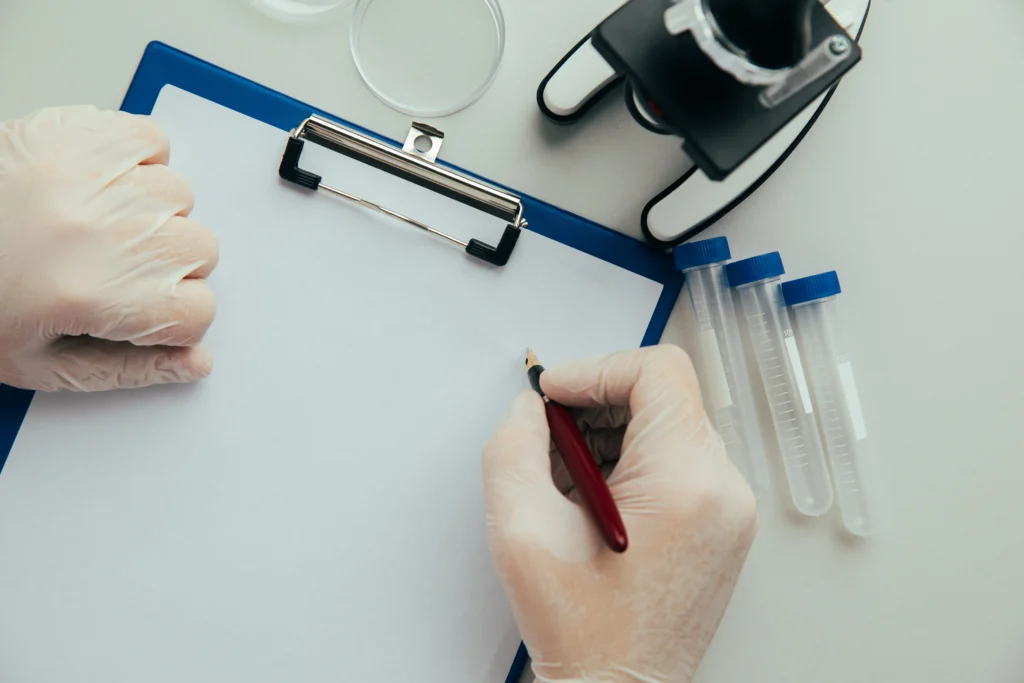 Tabla de anotaciones sostenida por un investigador a punto de escribir sobre ella.
